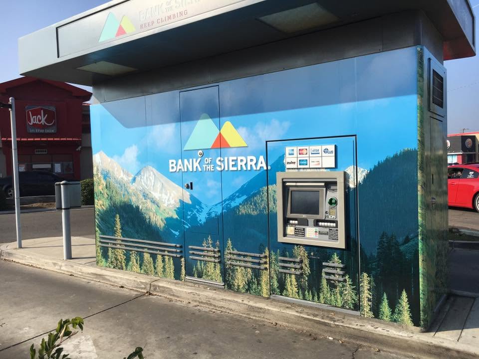 Bank of the Sierra ATM kiosk wrapped with a Sierra mountain and forest scene